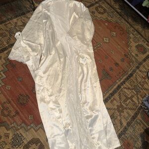 Bundle of white robes with lace trimming